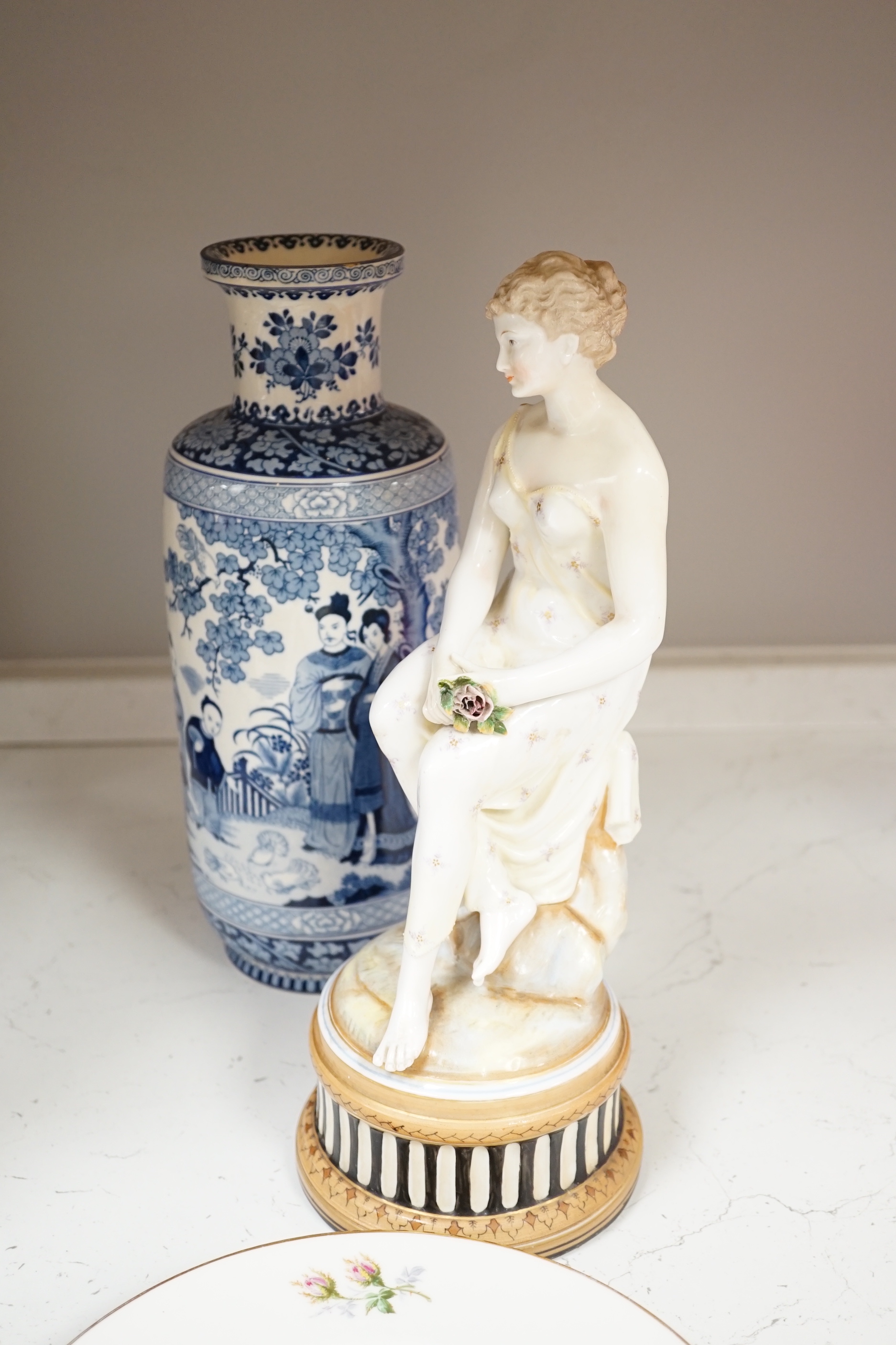 Eight porcelain items; a late 18th century Derby plate with painted scene of Coniston Lake, Lancashire, two floral painted Paris porcelain plates, a pair of Booths blue and white vases, a lidded vase, a Copeland blue gro